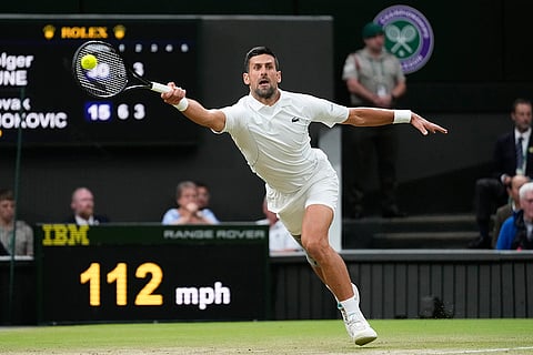 Novak Djokovic plays a forehand return to Holger Rune
